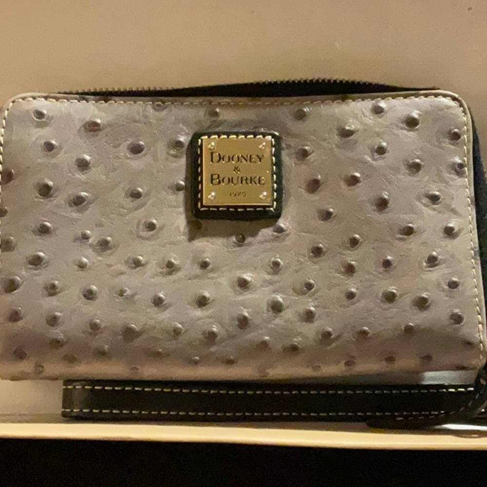 Dooney &Bourke wristlet like new never used . I phone 12 pro fits 6.5 by 3.5 in